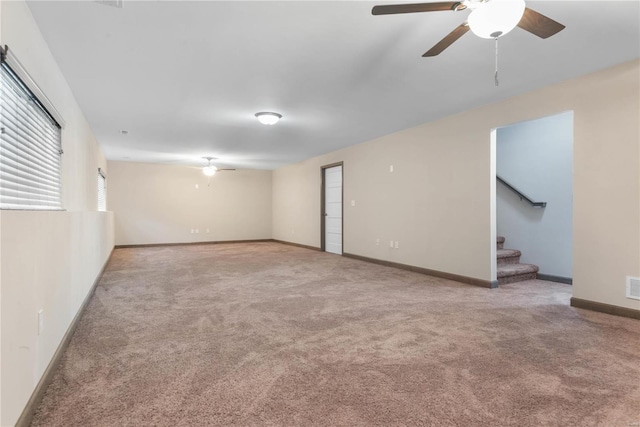 carpeted empty room featuring ceiling fan