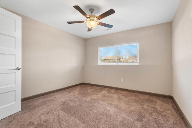 spare room with carpet floors and ceiling fan