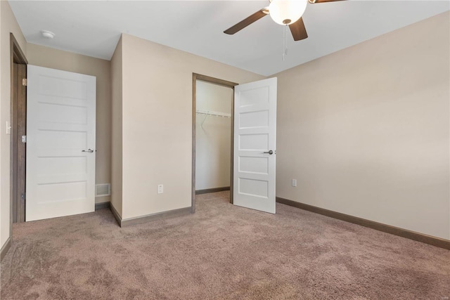 unfurnished bedroom with ceiling fan, a closet, and light colored carpet