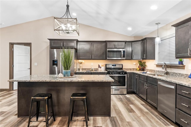 kitchen featuring pendant lighting, a center island, sink, and appliances with stainless steel finishes