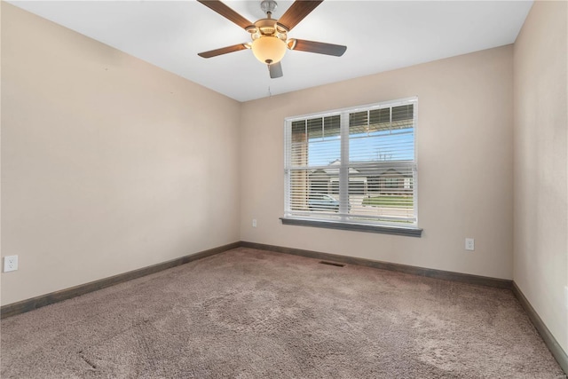 empty room featuring ceiling fan and carpet floors