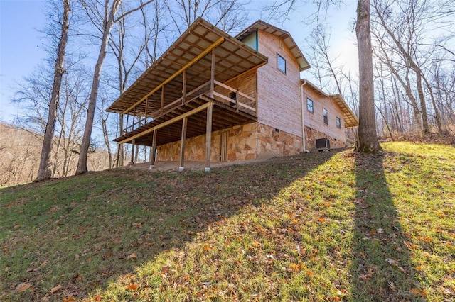 rear view of property featuring a yard and a wooden deck