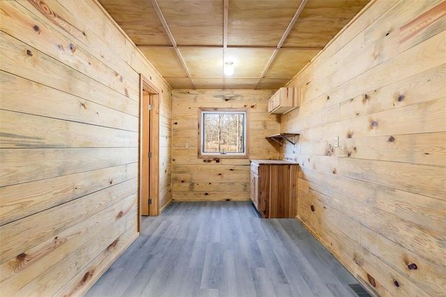 corridor featuring hardwood / wood-style flooring, wood walls, and wooden ceiling