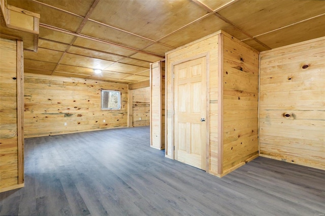 additional living space featuring wooden ceiling, dark wood-type flooring, and wood walls