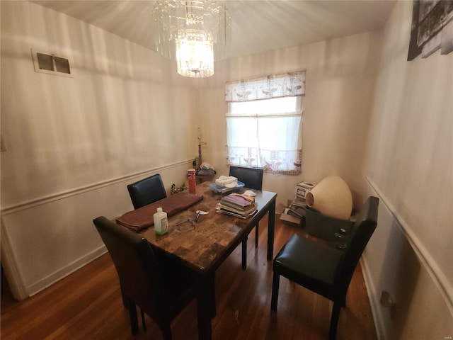 dining area featuring visible vents, dark wood finished floors, and a notable chandelier