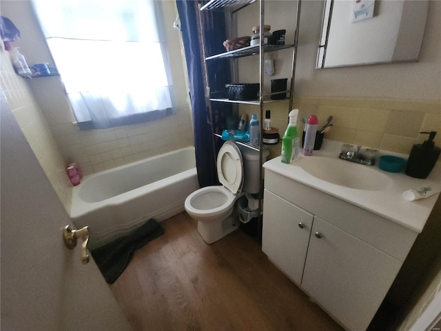 bathroom featuring vanity, wood finished floors, toilet, and shower / tub combo with curtain