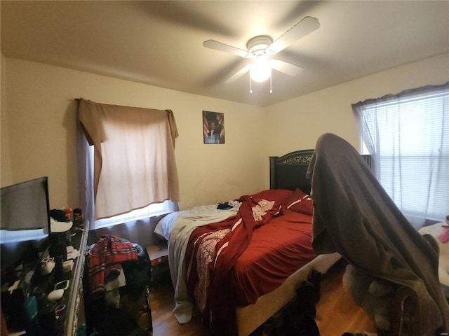 bedroom with a ceiling fan and wood finished floors