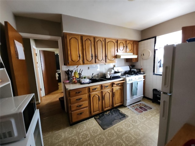 kitchen featuring sink and white appliances