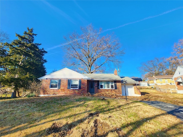 ranch-style home with a garage, a front lawn, and brick siding