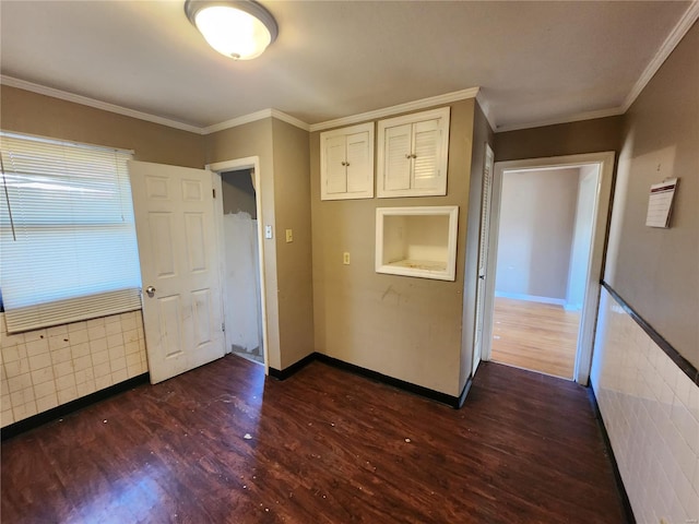 interior space with ornamental molding, dark wood-style flooring, and baseboards