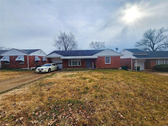 ranch-style home featuring a garage, a front lawn, and covered porch