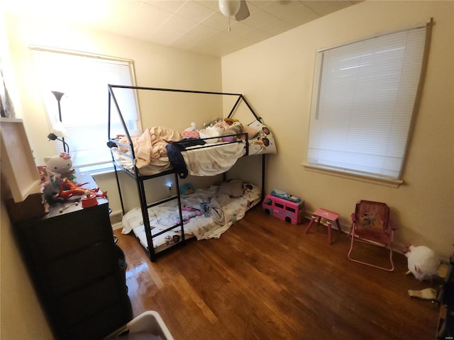 bedroom featuring dark hardwood / wood-style floors and ceiling fan