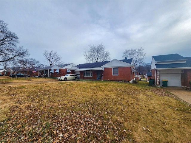 view of front of home featuring concrete driveway, brick siding, and a residential view