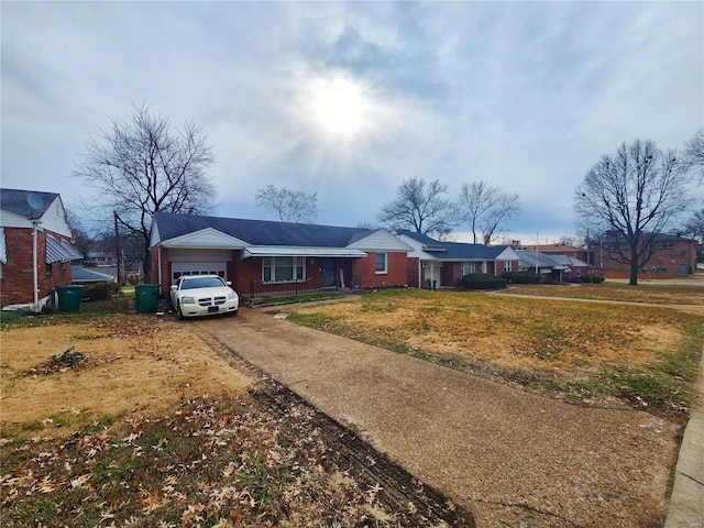 single story home featuring concrete driveway, brick siding, an attached garage, and a residential view