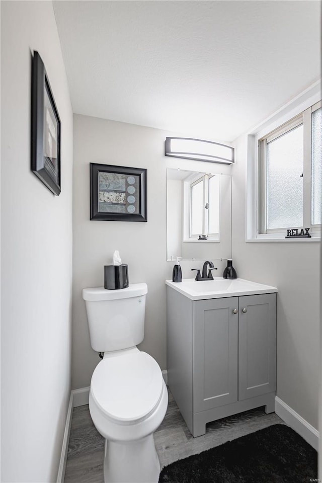 bathroom featuring hardwood / wood-style floors, vanity, and toilet