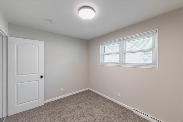 carpeted spare room with a baseboard radiator