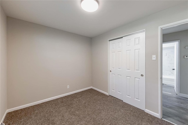 unfurnished bedroom with a closet and carpet floors