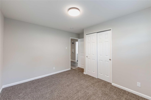 unfurnished bedroom featuring carpet floors and a closet