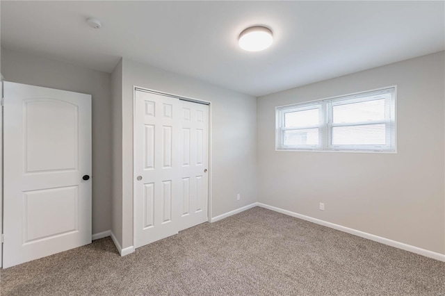 unfurnished bedroom with carpet floors and a closet