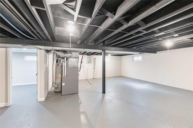 basement featuring electric panel and gas water heater