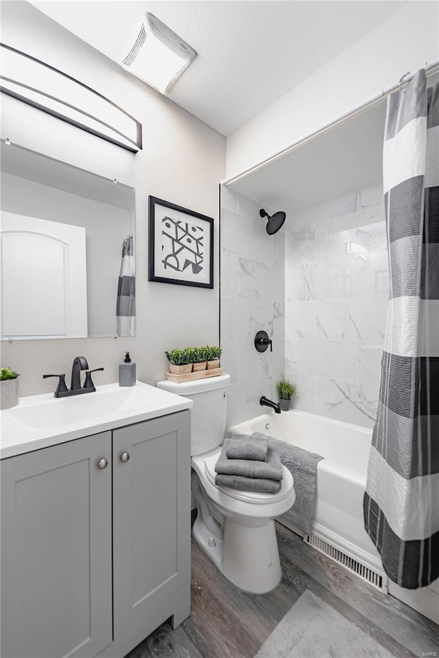 full bathroom with wood-type flooring, vanity, toilet, and shower / bathtub combination with curtain