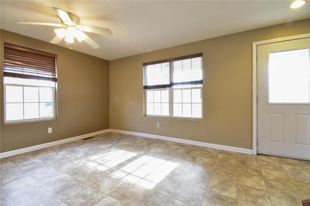 entrance foyer featuring ceiling fan and a wealth of natural light