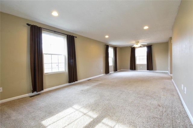 spare room featuring carpet flooring, plenty of natural light, and ceiling fan