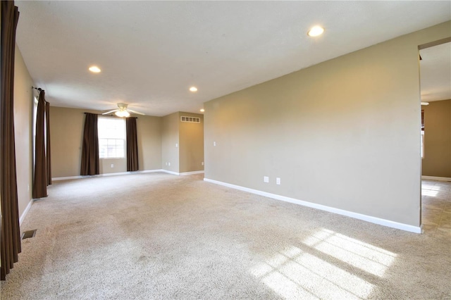 carpeted spare room with ceiling fan