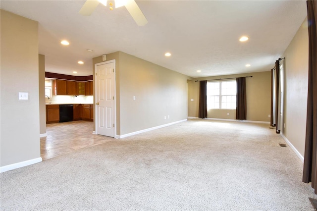 unfurnished living room featuring light colored carpet and ceiling fan