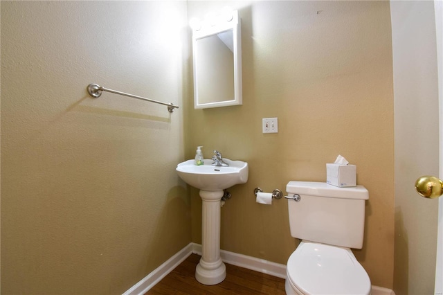 bathroom featuring toilet and hardwood / wood-style flooring