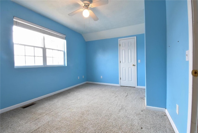 empty room with carpet, ceiling fan, and lofted ceiling