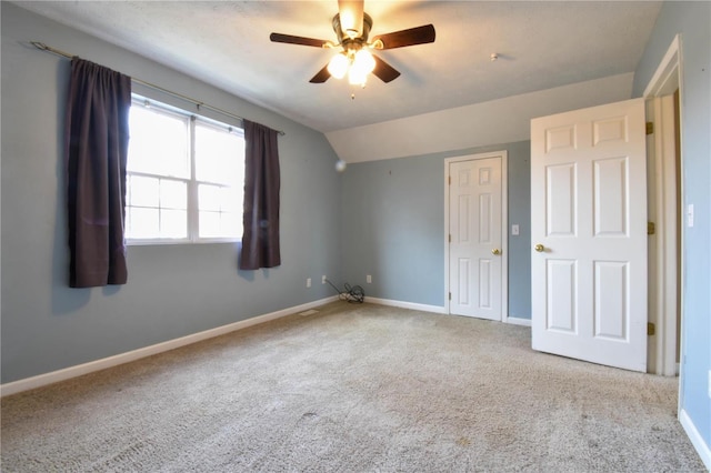 unfurnished bedroom with light carpet, vaulted ceiling, and ceiling fan