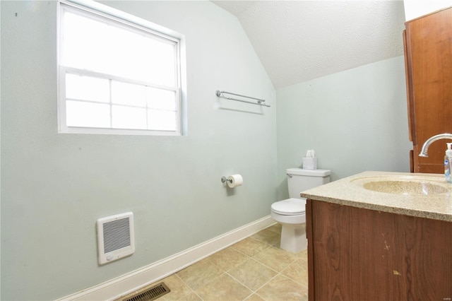 bathroom with a textured ceiling, vanity, tile patterned flooring, toilet, and lofted ceiling