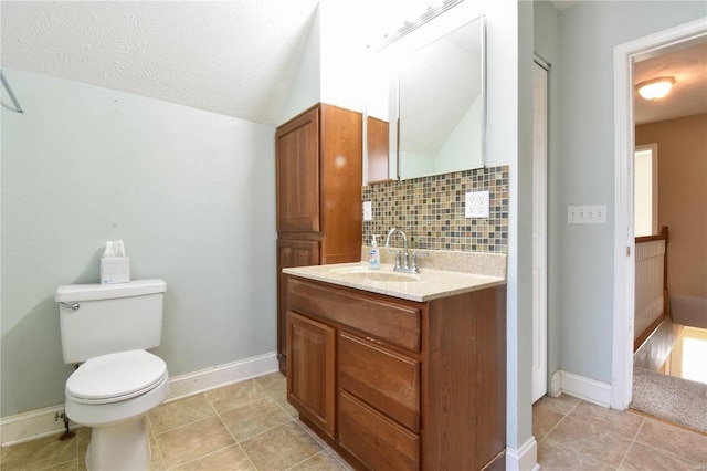 bathroom with decorative backsplash, vanity, a textured ceiling, and tile patterned flooring