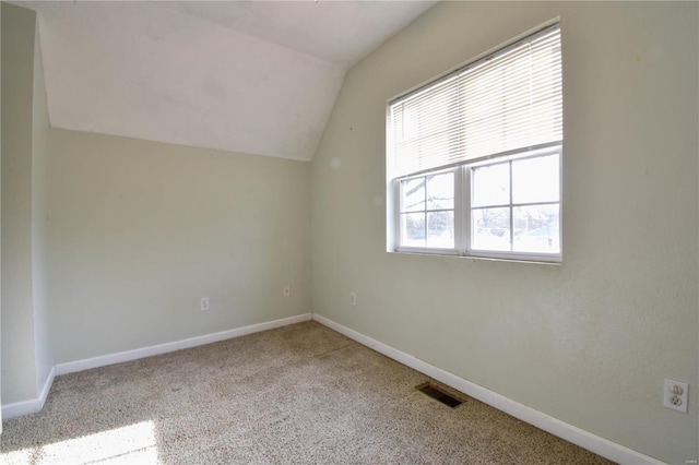 bonus room featuring light colored carpet and lofted ceiling