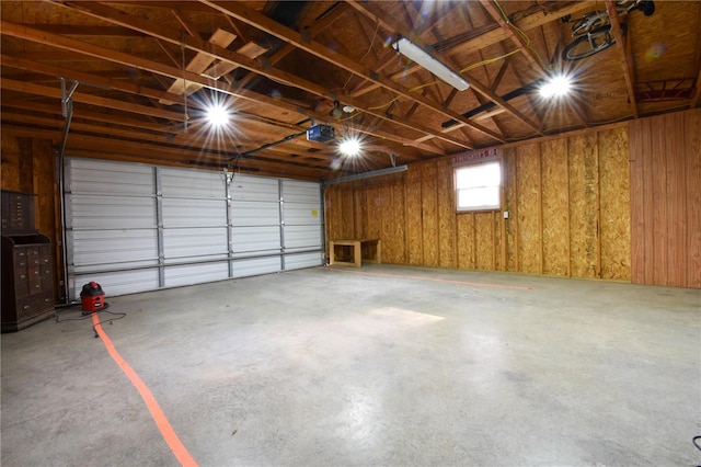 garage featuring wooden walls and a garage door opener