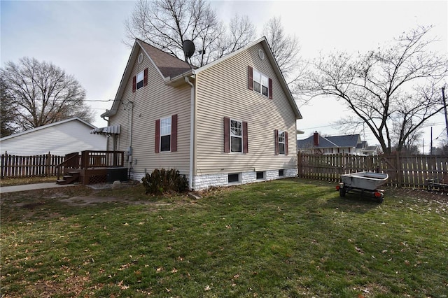 view of side of home with a yard and a wooden deck