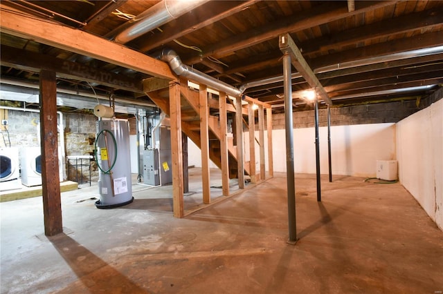 basement featuring washing machine and dryer, water heater, and heating unit