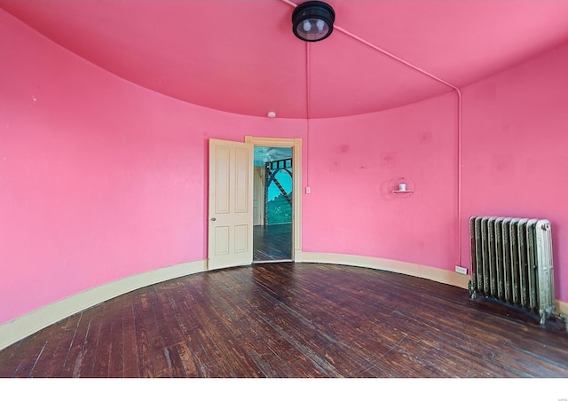 unfurnished room featuring hardwood / wood-style flooring and radiator