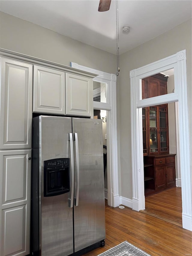 kitchen featuring stainless steel fridge with ice dispenser, ceiling fan, and wood-type flooring