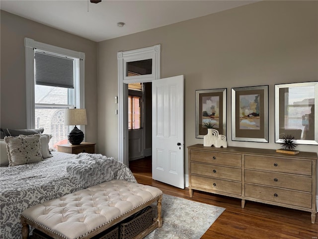 bedroom with dark wood-type flooring