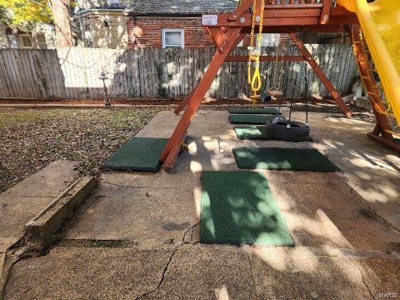 view of playground featuring a patio area