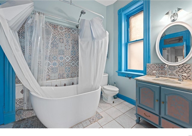 bathroom with tasteful backsplash, tile patterned flooring, vanity, and toilet