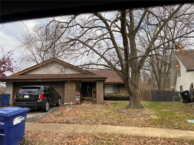 view of front of house featuring a front yard, a garage, and central air condition unit