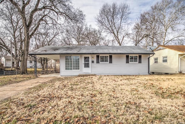 single story home featuring a carport and a front lawn