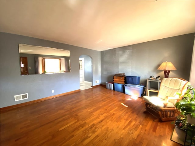 unfurnished living room featuring hardwood / wood-style floors and lofted ceiling