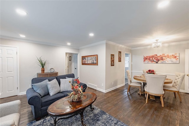 living room featuring a notable chandelier, dark hardwood / wood-style floors, and crown molding