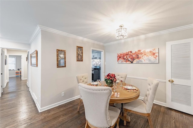 dining room featuring dark hardwood / wood-style flooring, an inviting chandelier, and ornamental molding