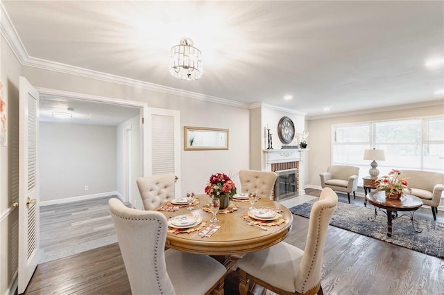 dining area featuring a chandelier, ornamental molding, a brick fireplace, and dark wood-type flooring