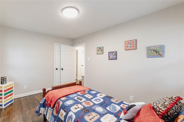 bedroom with dark hardwood / wood-style flooring